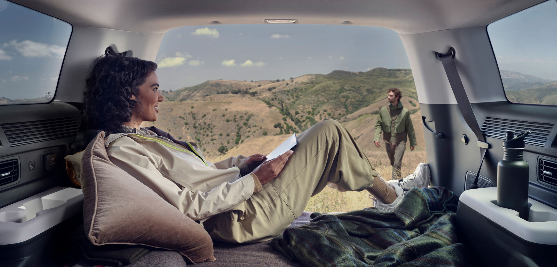 A woman gazes at a man strolling outside from within a SANTA FE